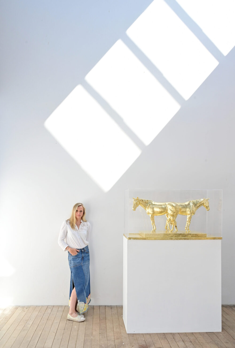 Sculptor Frippy Jameson at Marchmont House with her equine sculptures.