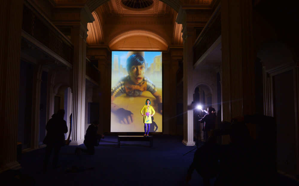 Contemporary artist Rachel Maclean attends her exhibition 'Spite Your Face' at Talbot Rice Gallery, Edinburgh's University Old College Maclean – who graduated from Edinburgh College of Art in 2009 - was selected to create a work to represent Scotland at the 2017 Venice Biennale. Visitors will be invited to sit or lie amidst the excessive opulence as they watch Spite Your Face, Rachel Maclean’s acclaimed video work. The film will be displayed on a monolithic portrait-format screen, suspended at one end of the Georgian Gallery. The free show runs 24 February to 5 May 2018. Playing on a 37-minute continuous loop with no discernible beginning or end, the film follows the rise and fall of Pic, a young boy whose journey to maturity is accompanied by moral corruption and a rise to celebrity and power.